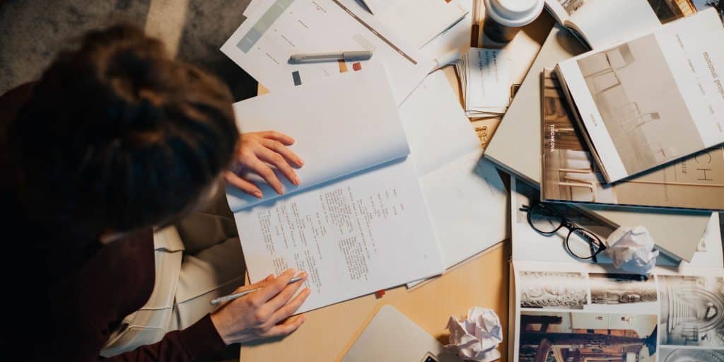 woman working at cluttered desk