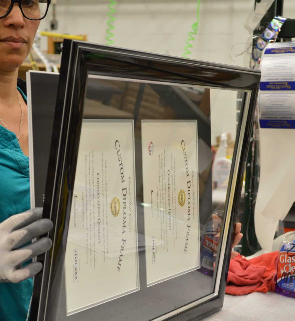 framer adding glass to double diploma frame