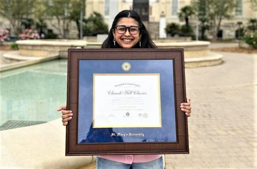 girl holding a st marys university diploma frame