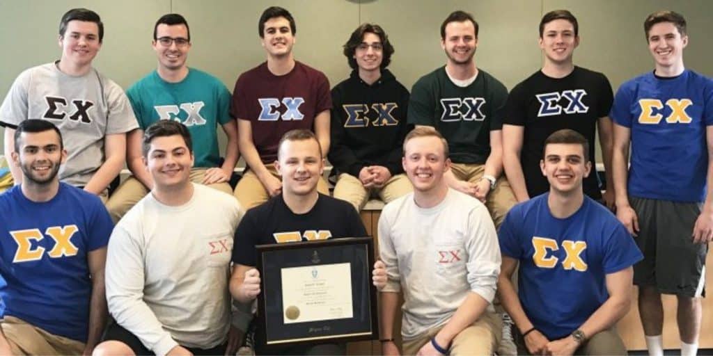 fraternity members holding chc frame