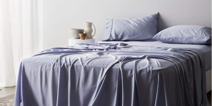 gray blue sheet set on bed