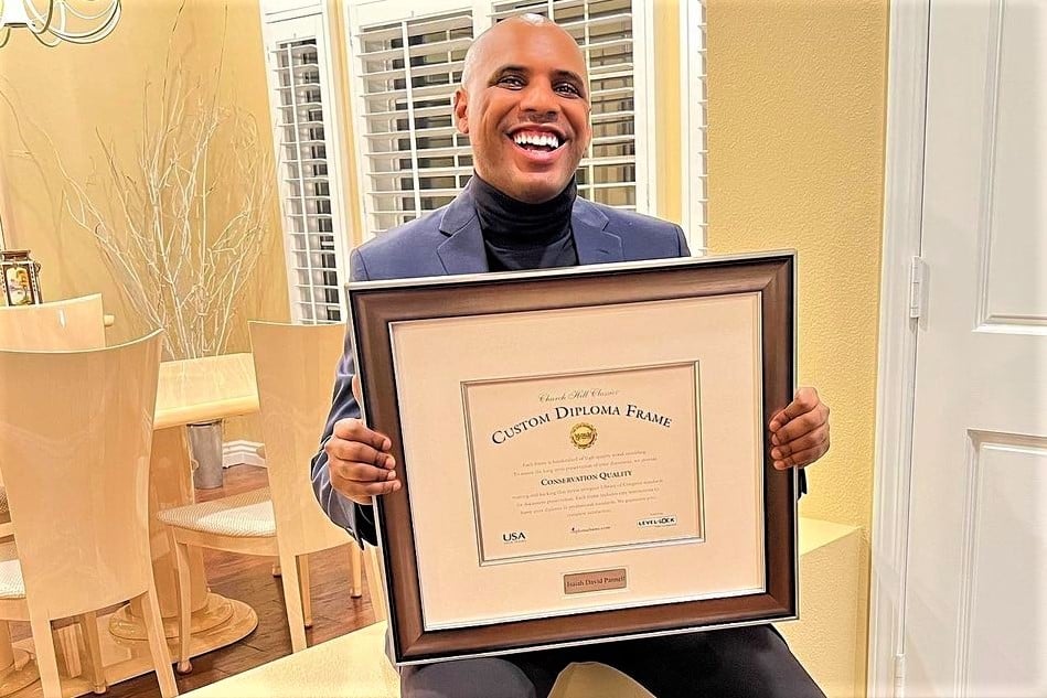 smiling man holding custom diploma frame