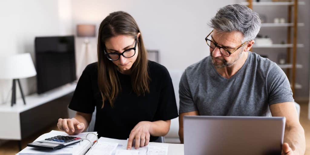 man and woman looking at tax papers