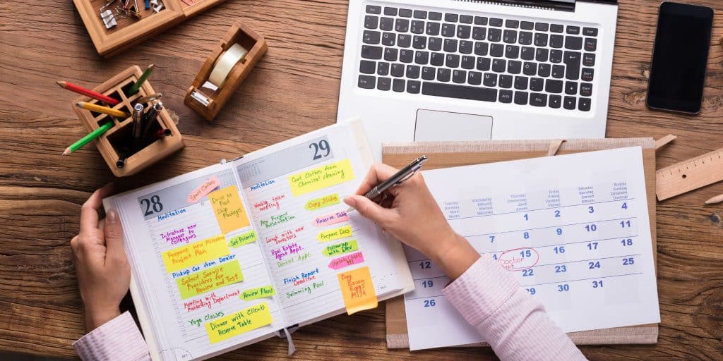 filling out schedule at desk