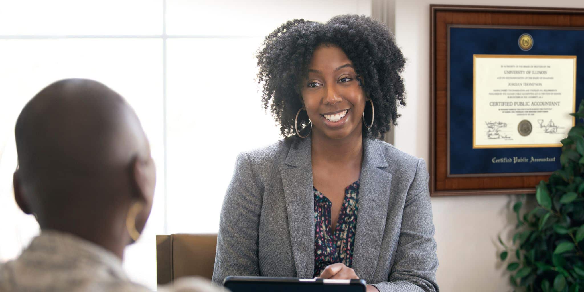 female CPA talking to client with frame in back