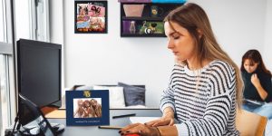 college student working in dorm room with Marquette University photo frame on desk