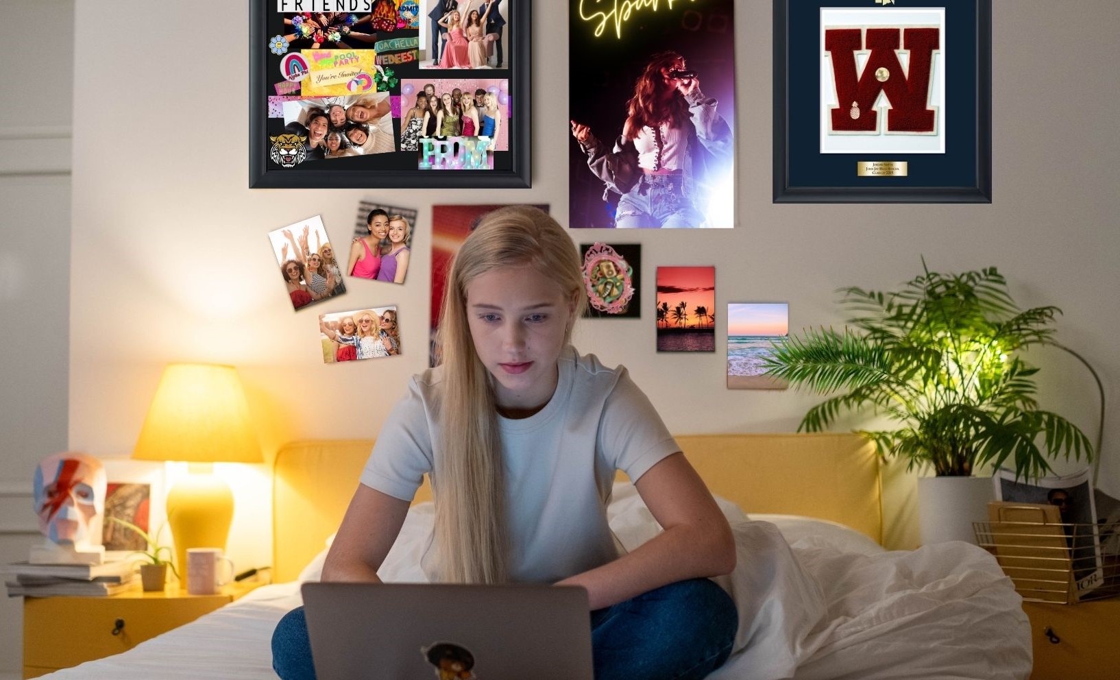 teen on laptop in room with varsity letter frame and shadowbox on wall