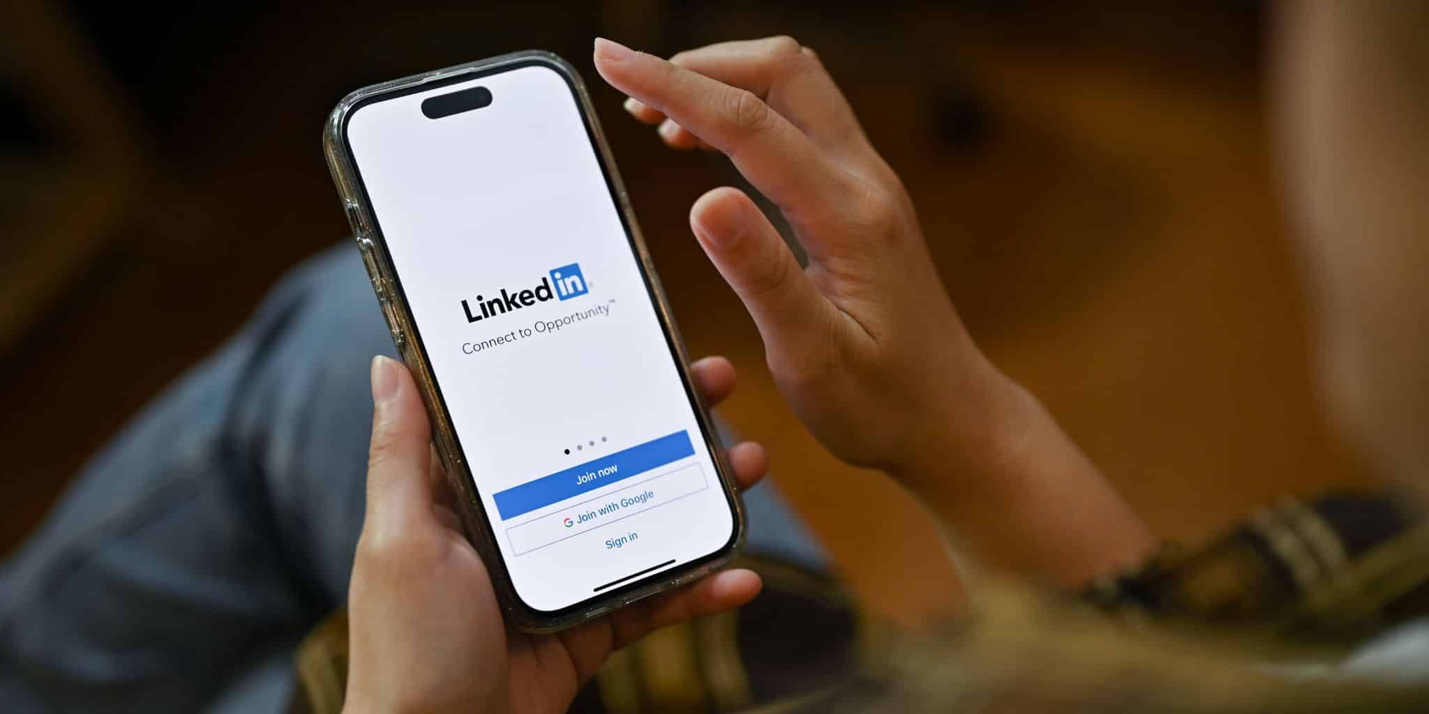 hands holding phone with linkedin app intro screen