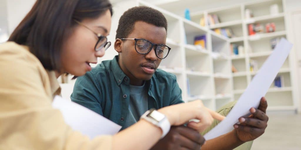 two students looking at paper