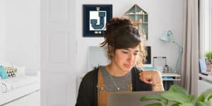girl at computer with varsity letter frame behind her