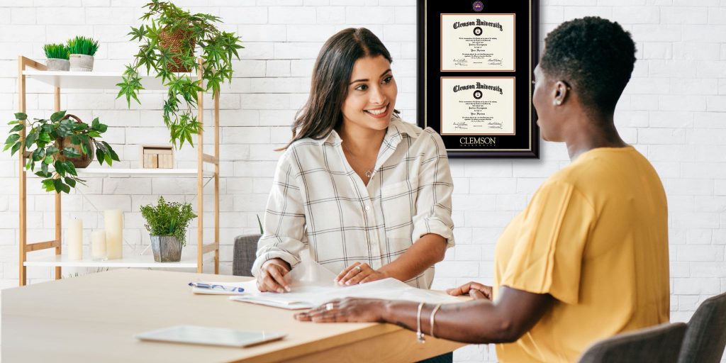 woman at desk with interviewee in office