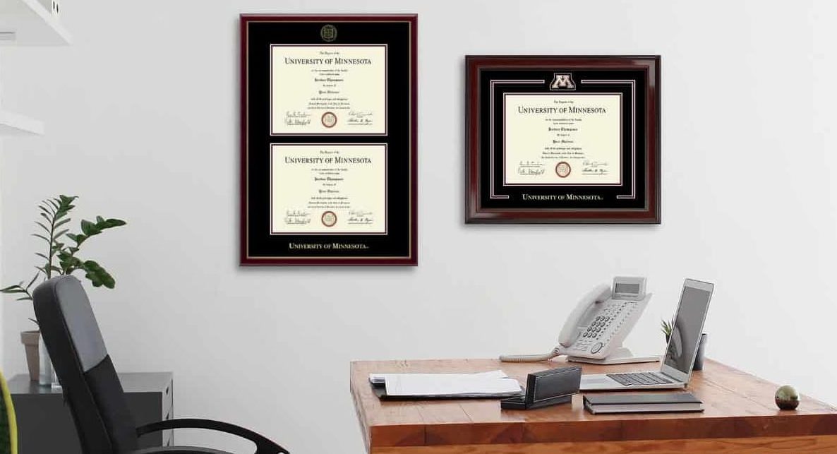 two university of minnesota frames hanging on office wall