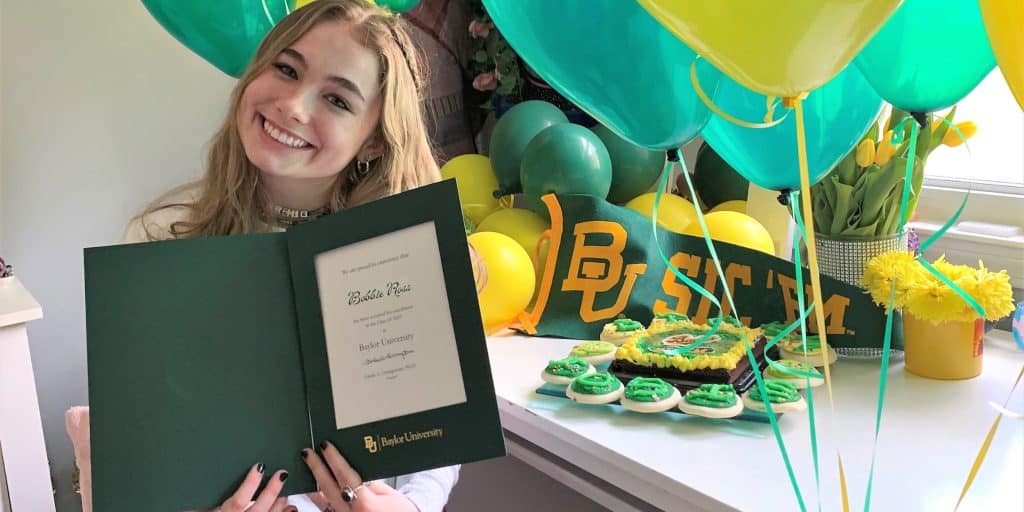 high school senior holding acceptance letter to baylor university