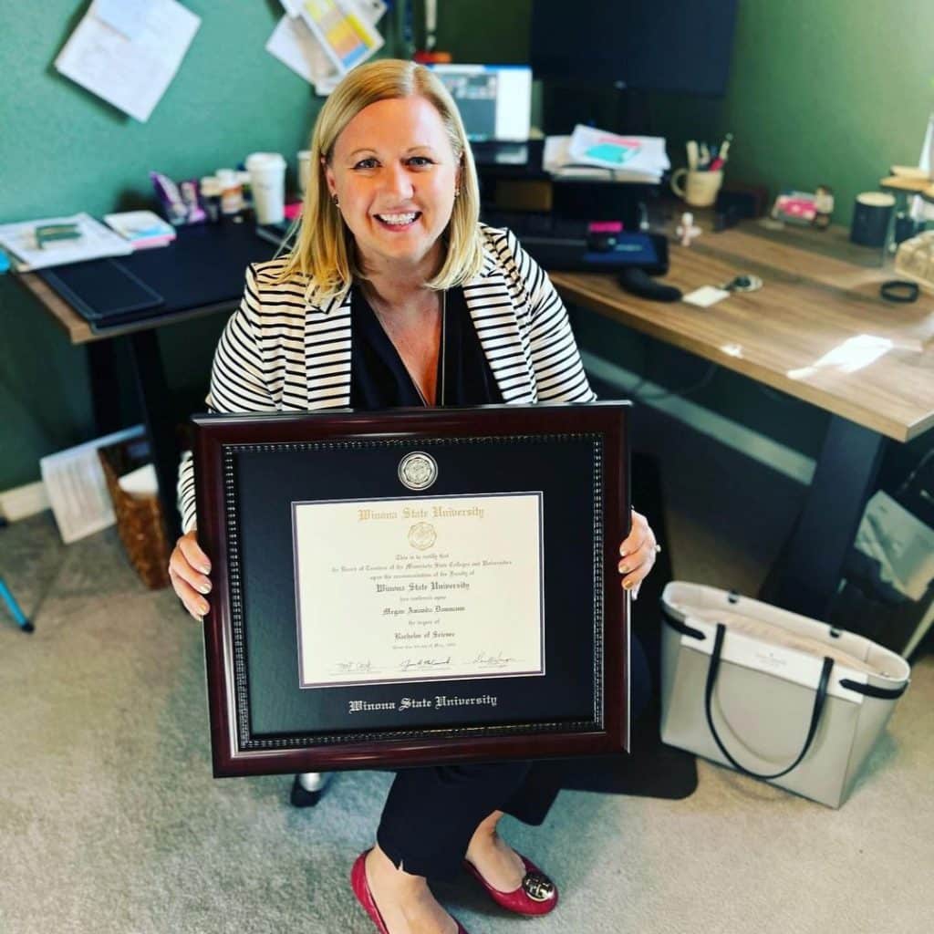 graduate in office with winona state diploma frame
