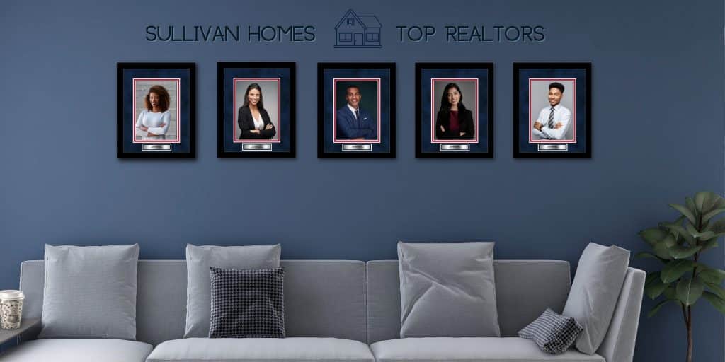 frames of top performing realtors on wall