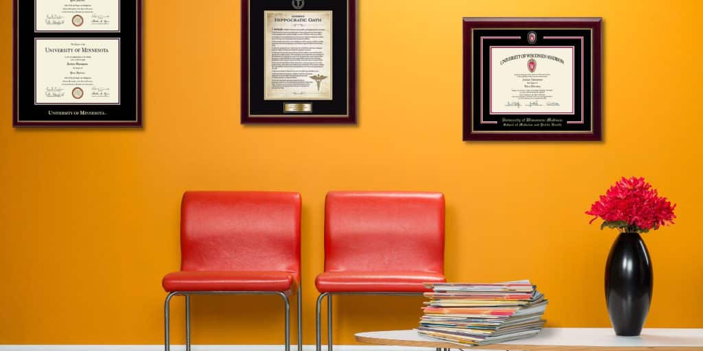 waiting room with framed medical degrees and hippocratic oath