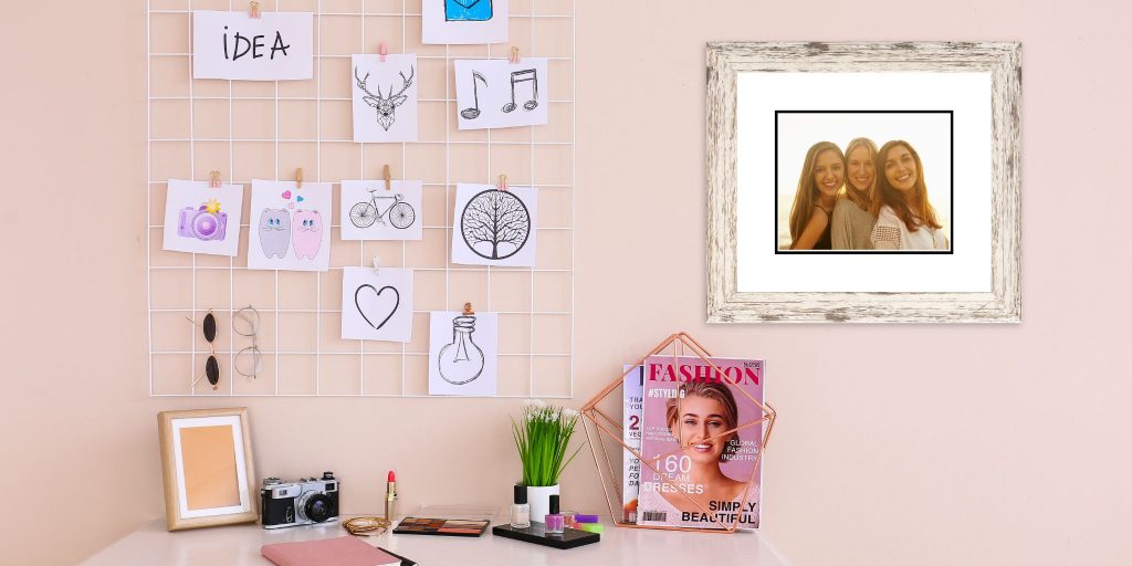 teenage girl desk in pink room with photo frames and stuff on desk and custom Church Hill Classics photo frame on wall