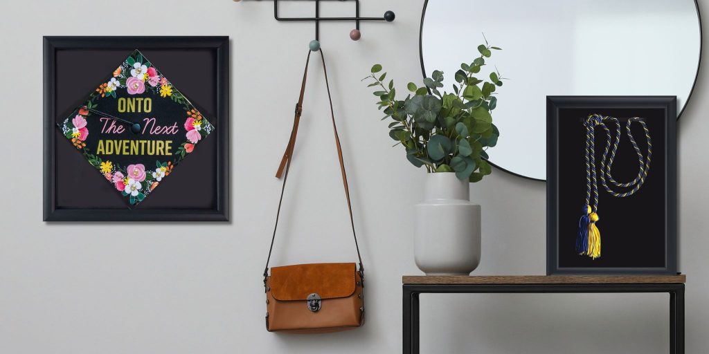 wall with entryway decorations and a decorated graduation cap and honor stole in separate Church Hill Classics shadow boxes