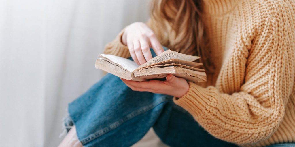 person sitting and reading a book