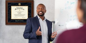 professor teaching in front of morehouse college frame
