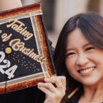 graduatessmiling and posing with decorated grad cap