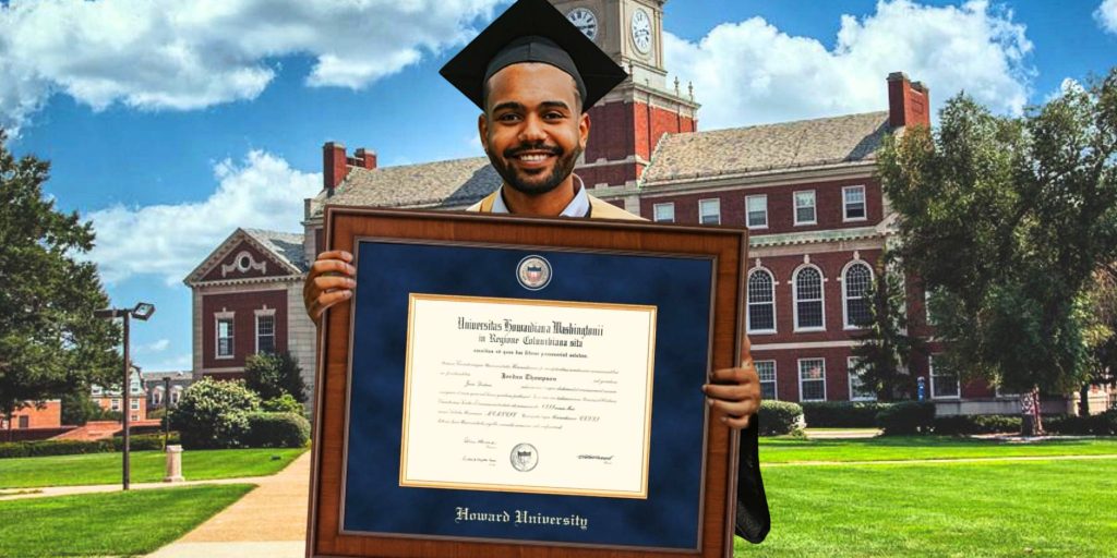grad holding his howard university diploma frame