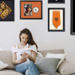 woman on couch with princeton graduation frames on wall above her