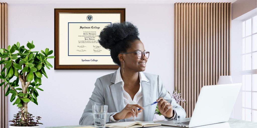 woman in office with spelman diploma frame on wall
