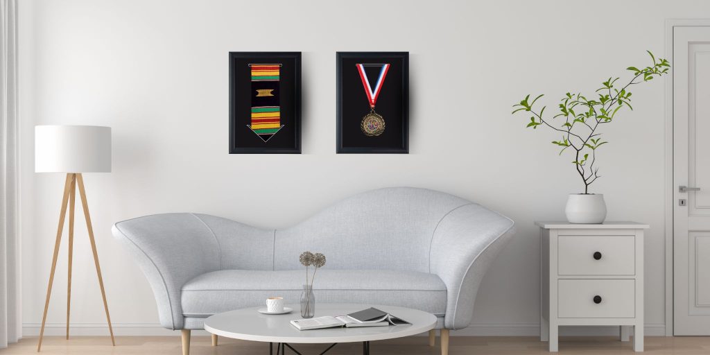 graduation stole frame and medallion frame on wall above couch