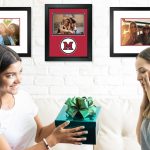 brunette teen handing gift with green bow to surprised blonde roommate