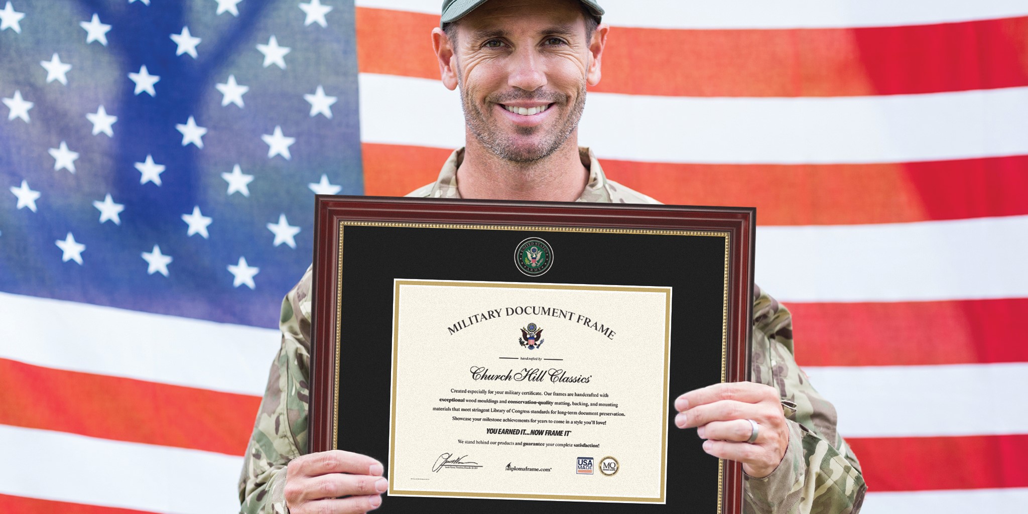smiling soldier holding army certificate frame in front of american flag