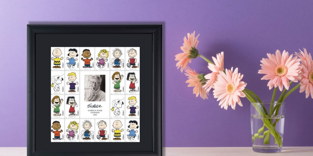 Peanuts stamp in frame next to vase of flowers