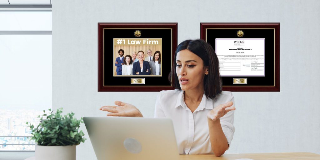 woman on Zoom call in office with framed award and certificate on wall