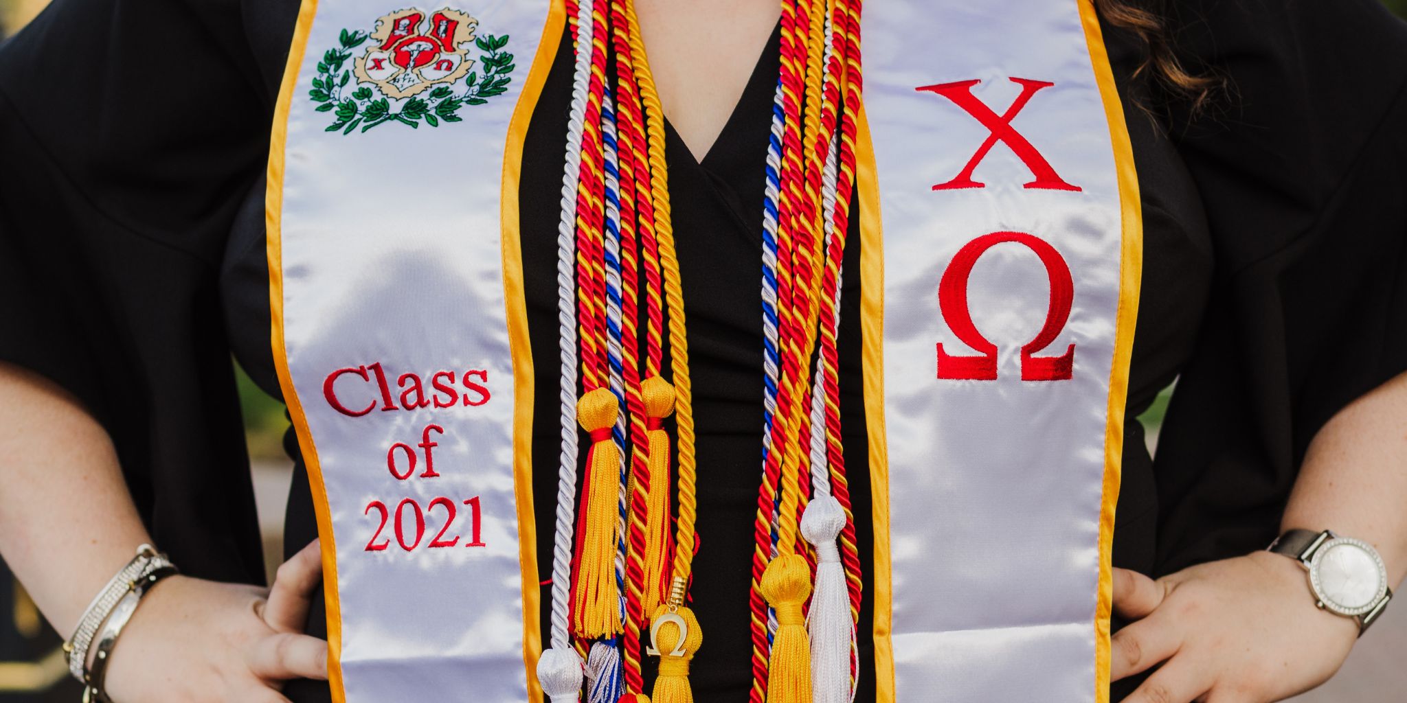 greek org honor stole and mutliple graduate cords on graduate
