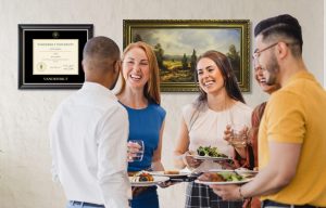 group of people mingling over food in front of wall with vanderbilt diploma frame