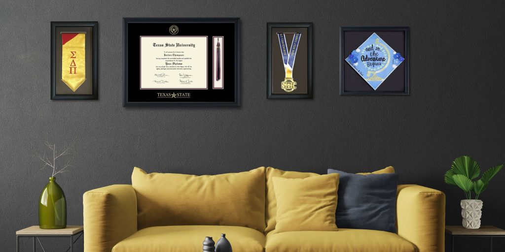 framed graduation stole college degree medallion and grad cap on wall