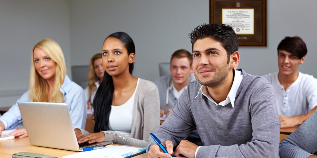 college students in class with brown university degree frame behind them