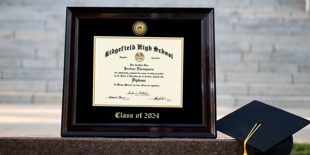 valedictorian class of 2024 diploma frame next to graduation cap