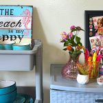 Shelves with vases, custom shadow boxes, supplies, and art in a dorm room