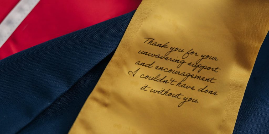 closeup of stole of gratitude message on a yellow graduation stole