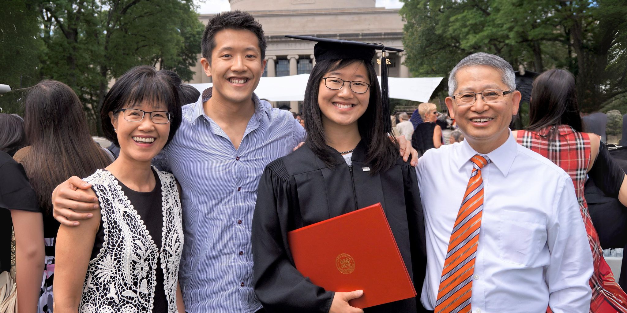 smiling family celebrating their daughter graduating from MIT