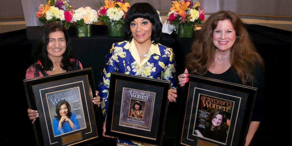 three successful businesswomen holding custom display frames made by Church Hill Classics