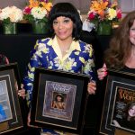 three successful businesswomen holding custom display frames made by Church Hill Classics
