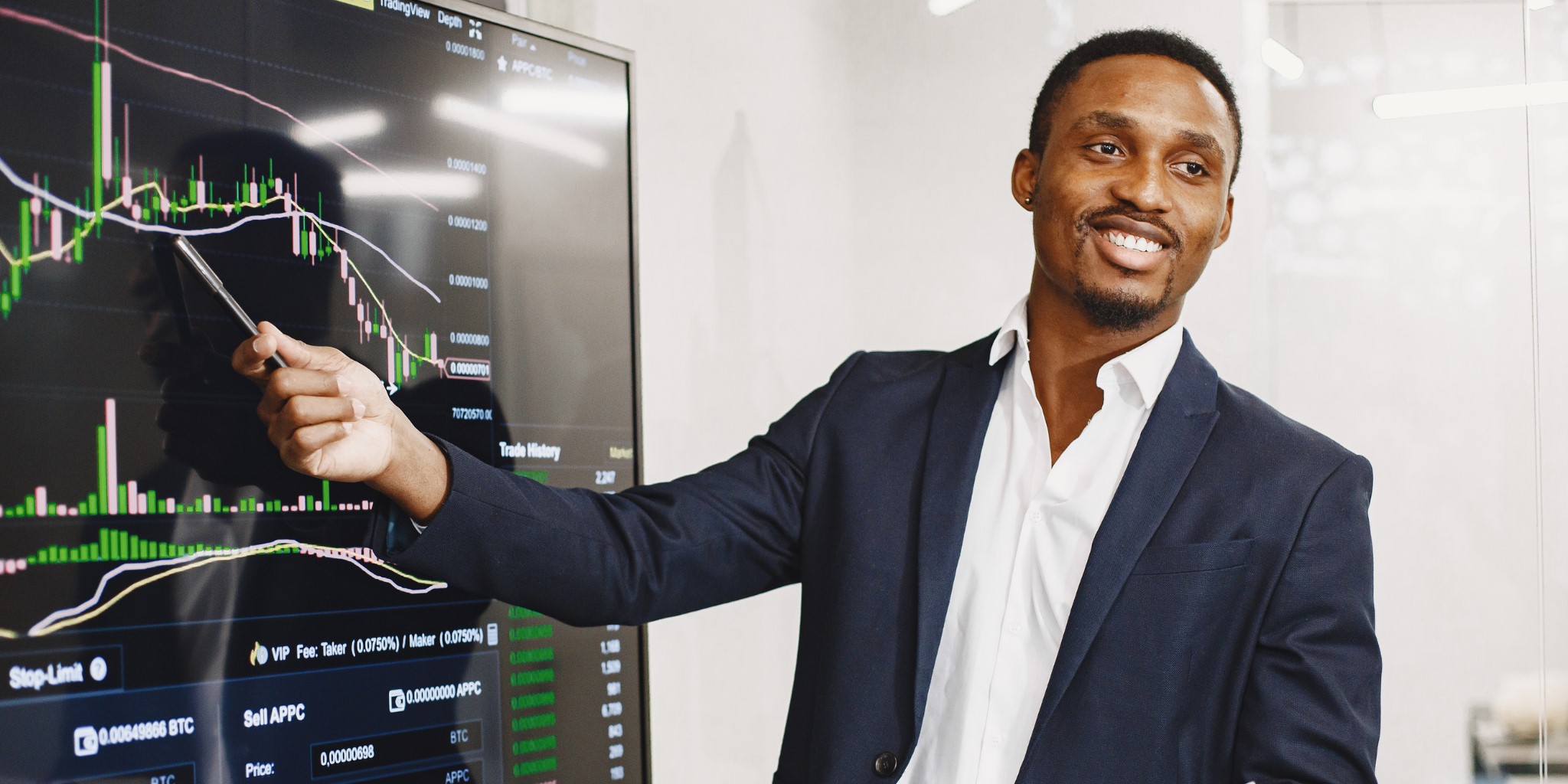 Man in suit holding pointer against screen showing business marketing chart.
