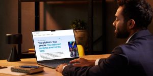 Closeup of businessman at desk working on Tableau platform on his laptop.