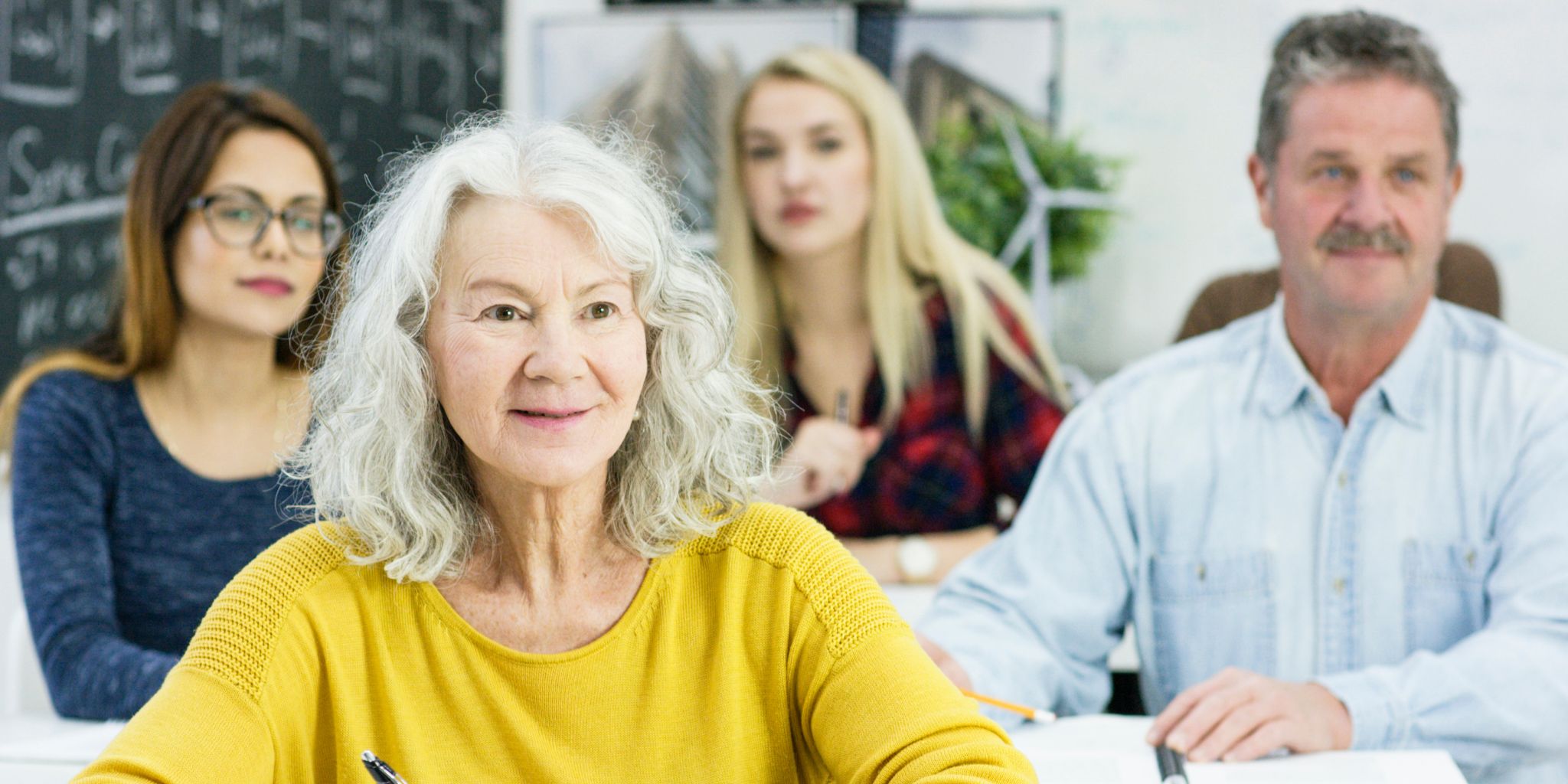 Older people sitting in college class and learning.