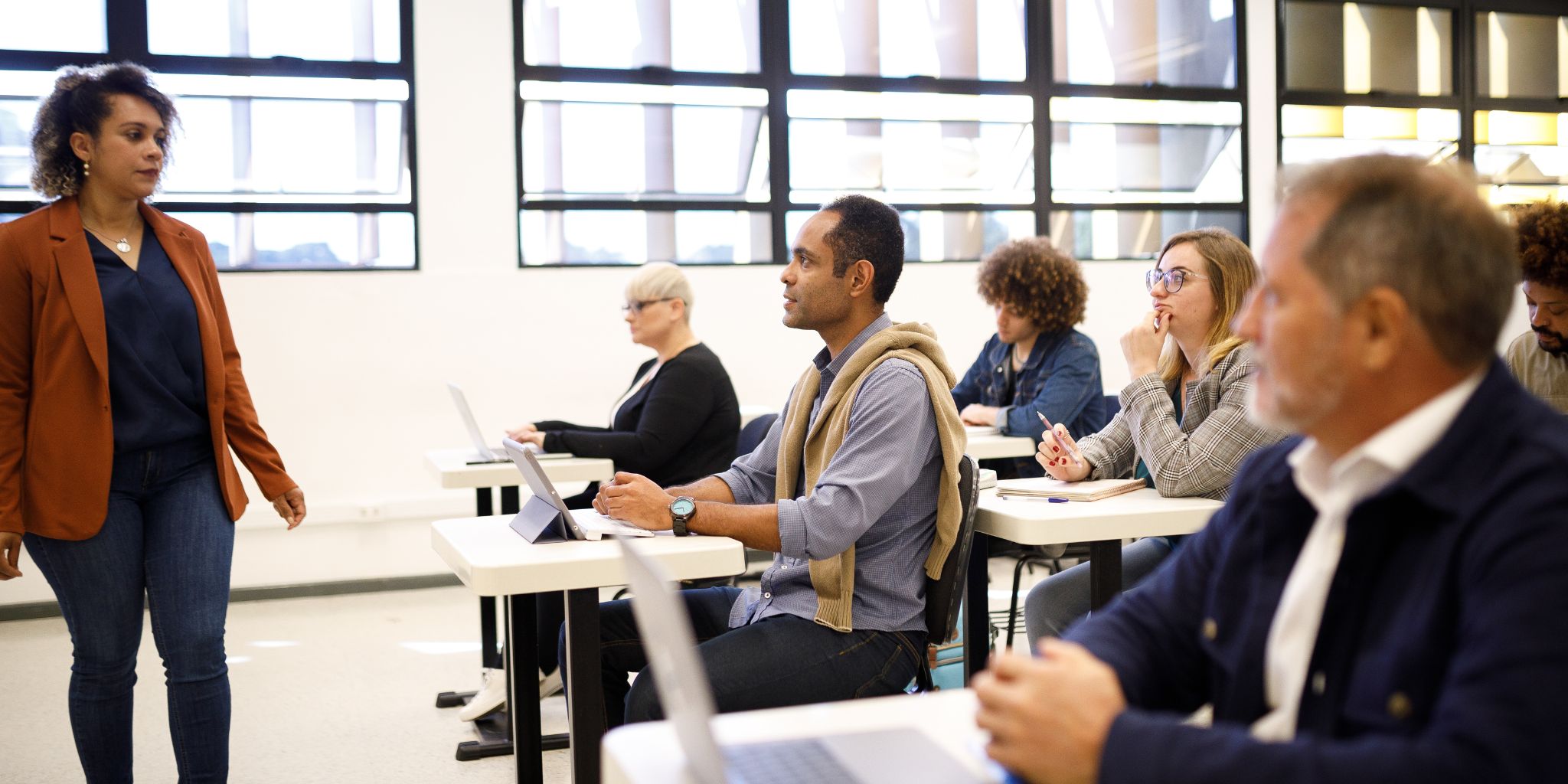 Classroom with teacher in front of class and adult education students.