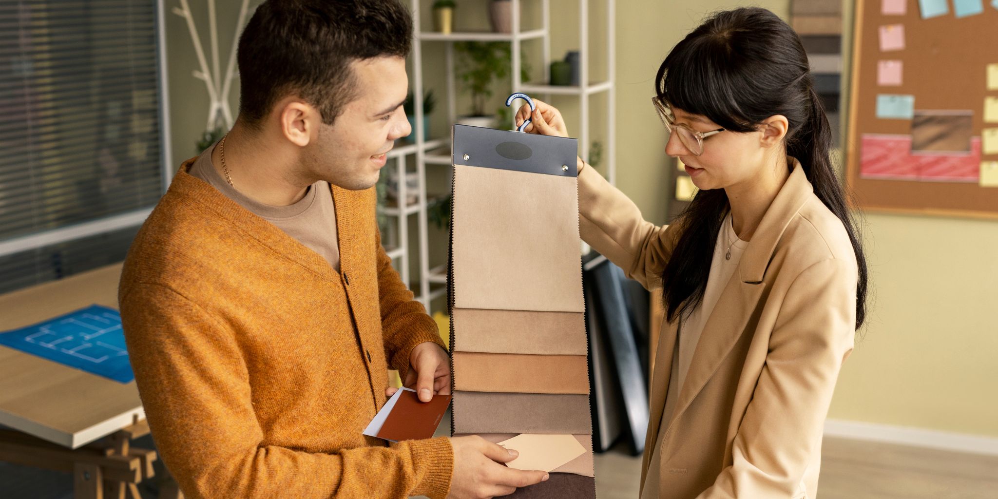 Person holding fabric samples for the customer with color swatches of mats trying to match the color.