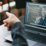 Person interacting with an online college tutor on a laptop