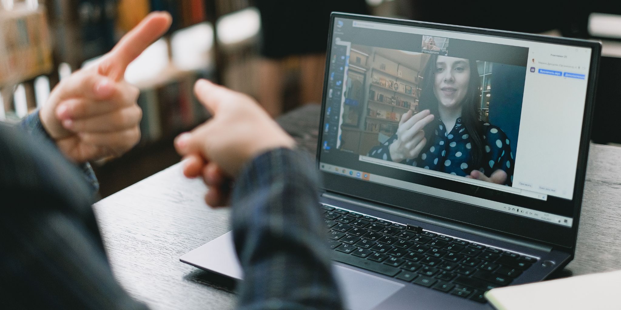 Person interacting with an online college tutor on a laptop